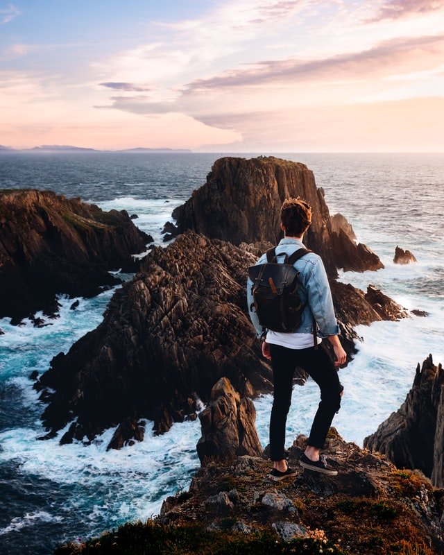 Man standing near cliff on the Irish coast.